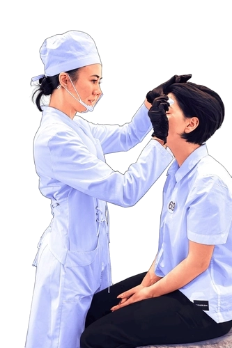 Violetta Shumskaya on the left in profile working on the brows of a client on the right.